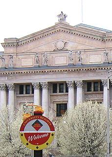 [Sign outside Old Courthouse announces the University Heights district to visitors]