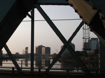 [Downtown bldgs framed by bridge elements, representational]